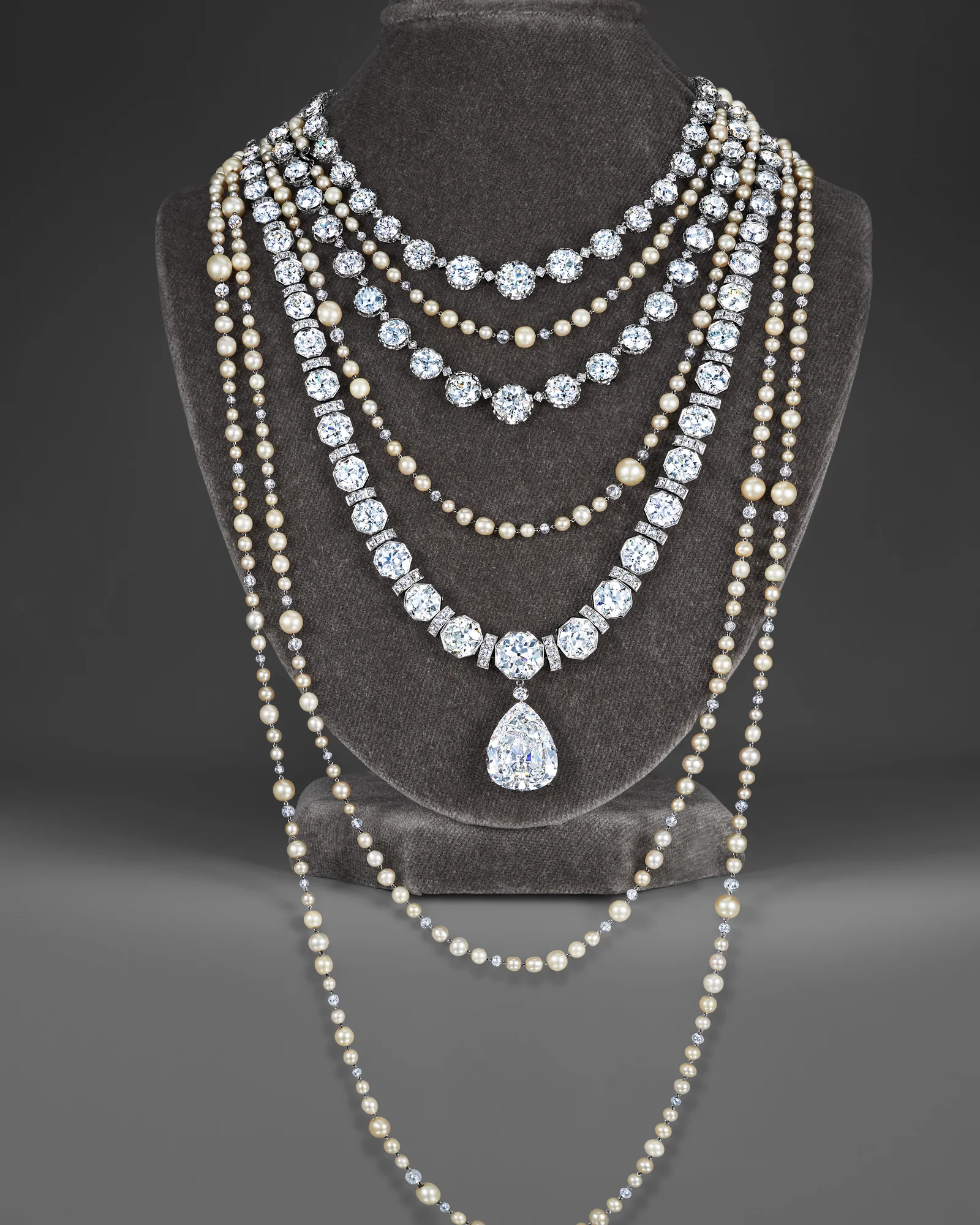A major collection of Fred Leighton diamond and pearl necklaces on a velvet bust