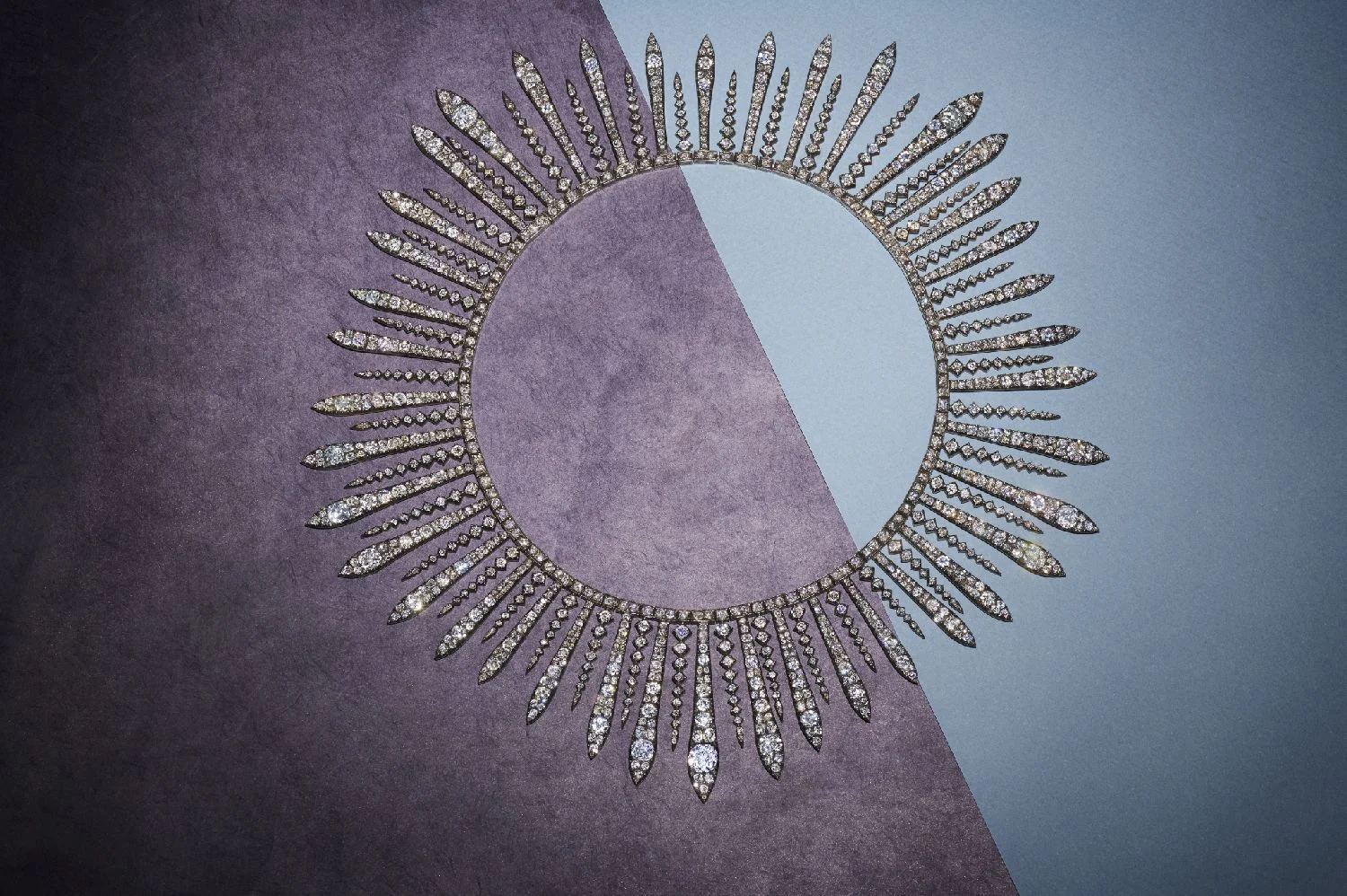 An important Fred Leighton diamond sunburst necklace on a blue and plum surface